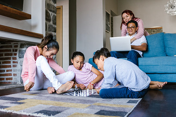 kids playing chess while parents watch