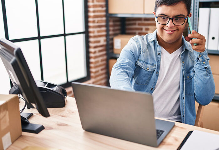 Man with down syndrome on a computer