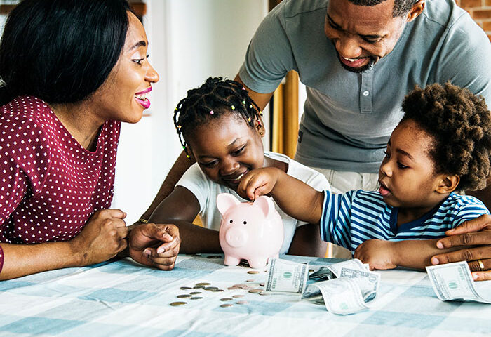Family saving money with a piggy bank and teaching kids about it