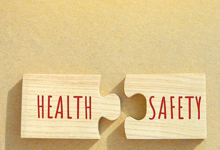 Health puzzle piece fitting into safety puzzle piece