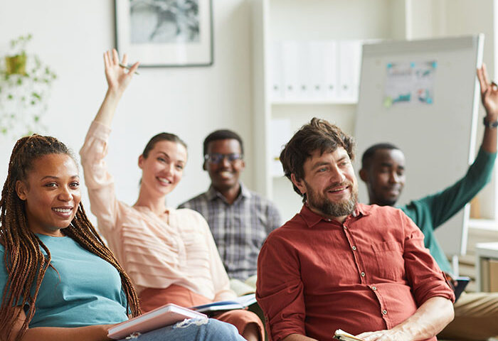 Adult class with some raising their hands
